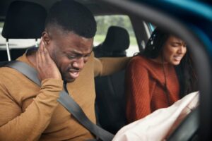 two passengers in pain and distress after a car accident