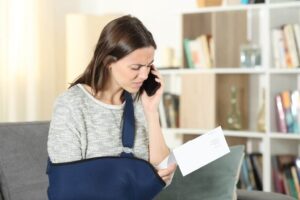 woman on the phone with insurance after being injured in an accident