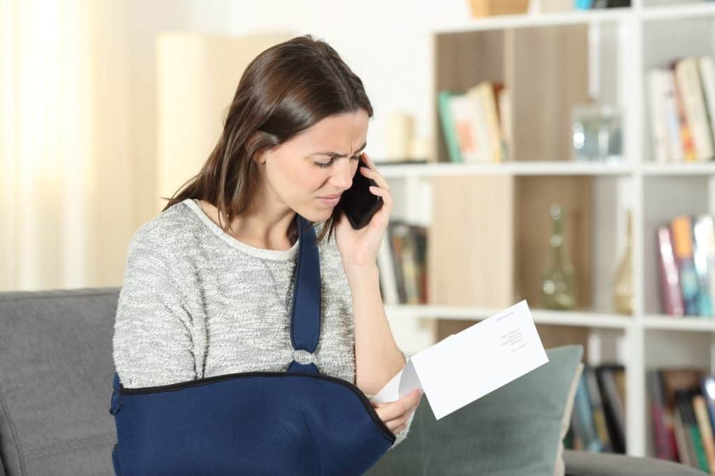woman on the phone with insurance after being injured in an accident