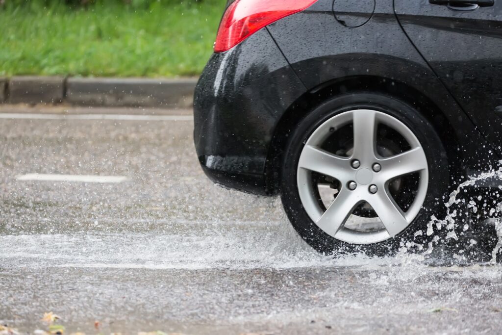 car driving through puddle of water