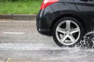 car driving through puddle of water