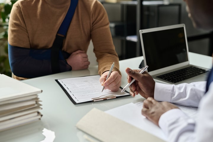 individual signing legal documents with attorney