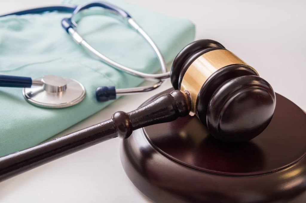 gavel, stethoscope, and scrubs