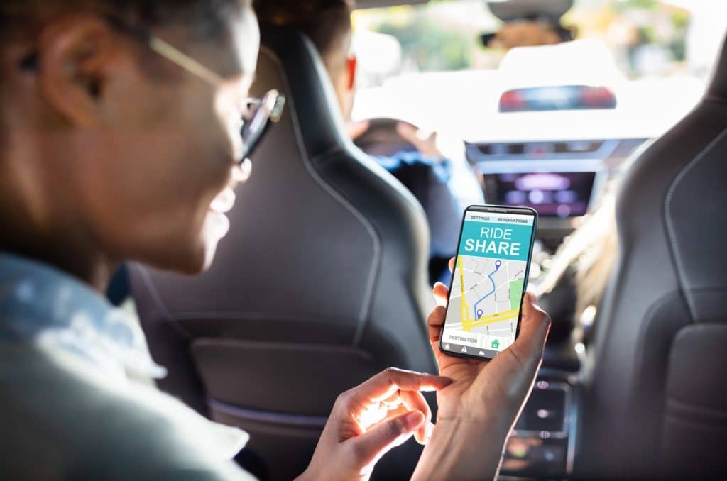 Rideshare App person looking at rideshare app in vehicle