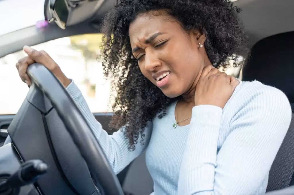 woman experiencing neck pain after a car accident