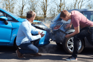 two men investigating the damage of their vehicles after a rear-end accident