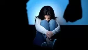 girl crawled up in a ball and in distress
