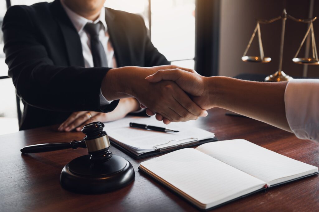 attorney shaking client's hand in law office