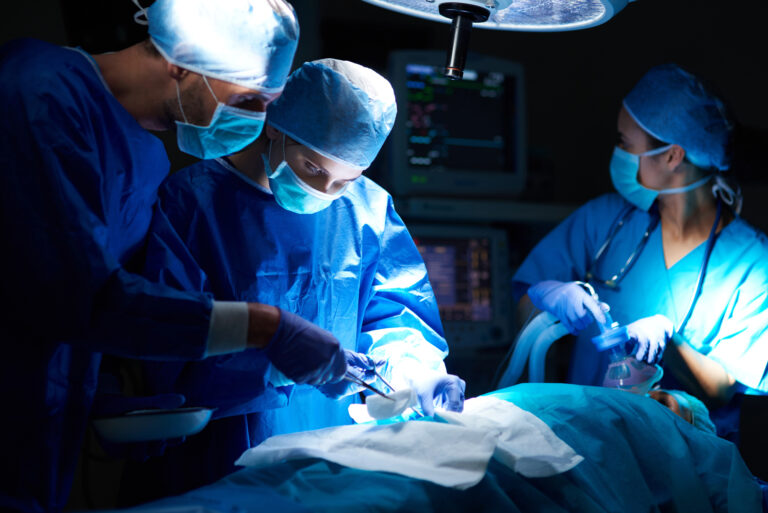 doctors and nurses performing surgery on patient