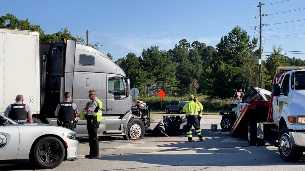 Centennial truck accident case Augusta, Ga USA - 09 23 2021: Semi truck and pickup truck collision car wreck and Police officers on scene on Highway 1