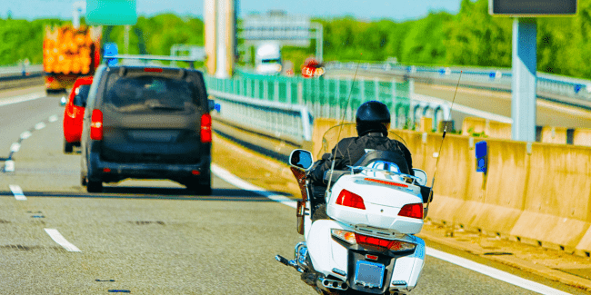 person riding motorcycle on road